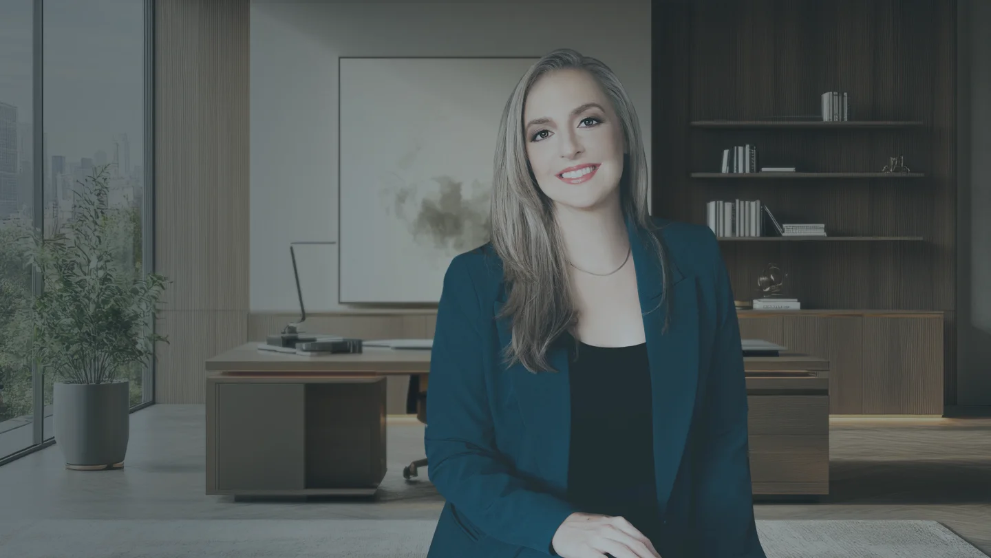 Brittany Quintana sitting on a table in a fancy office